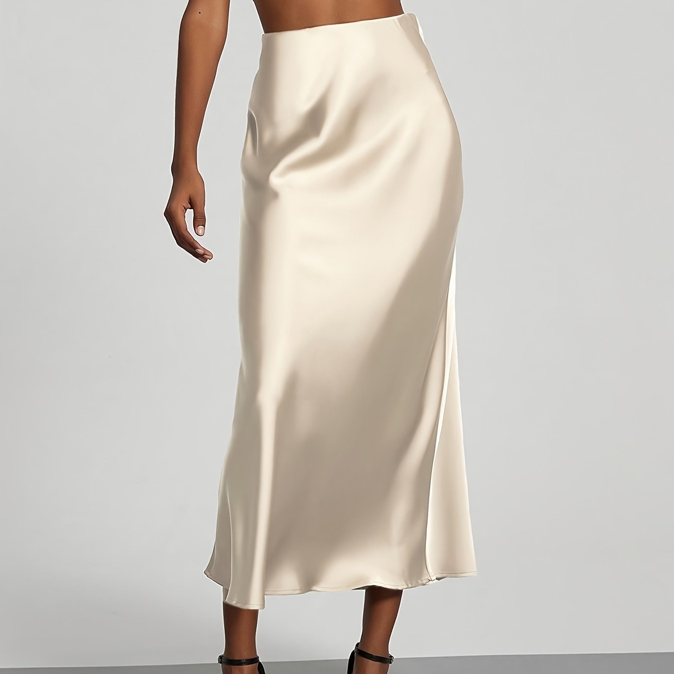 Elegant black high-waisted maxi skirt with A-line cut and smooth satin fabric, perfect for any occasion. Casual chic at its best.