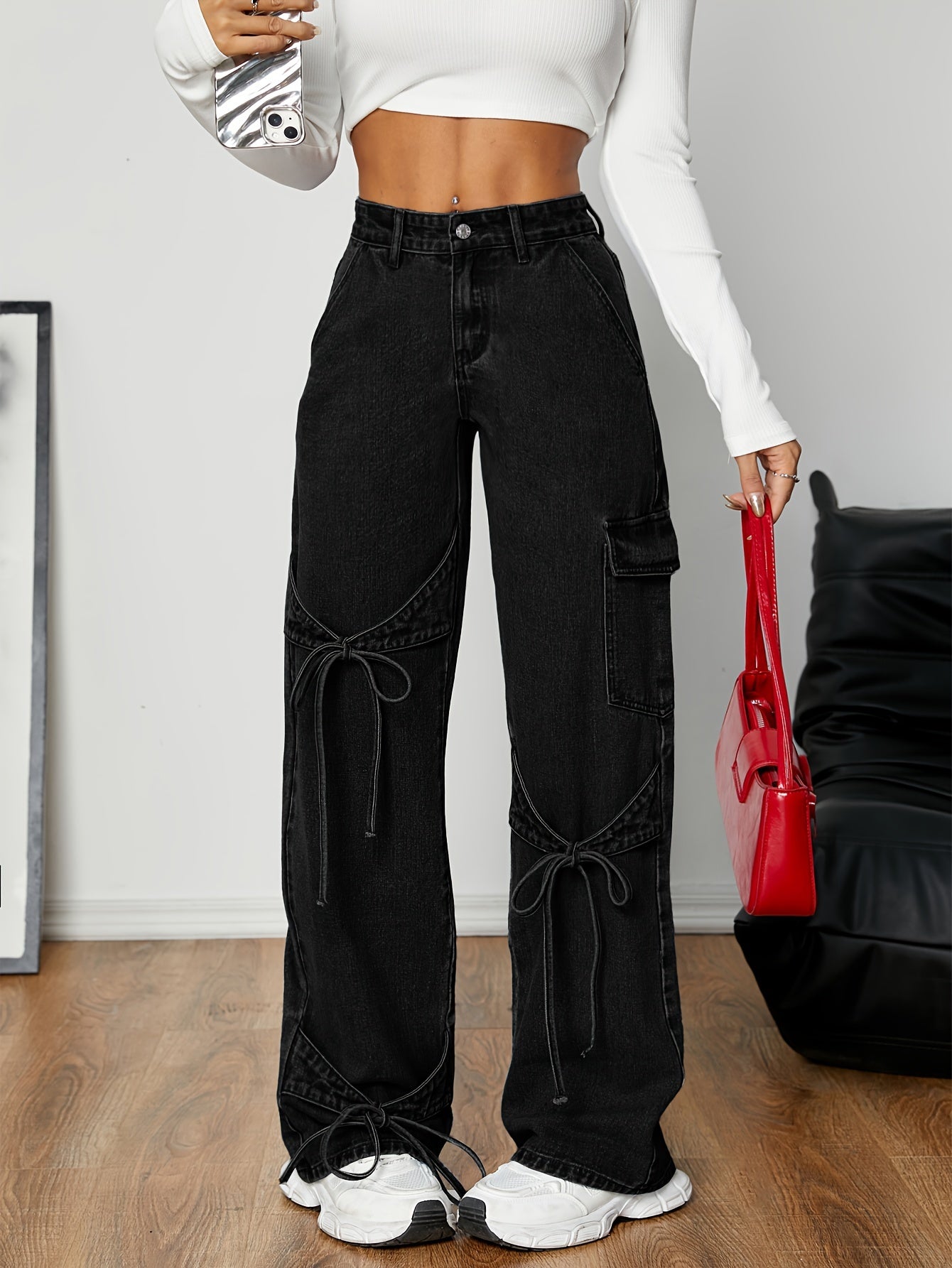 Stylish black cargo jeans for women with wide-leg and bow tie detail. Made from a non-stretch rayon blend, machine washable. Ideal for Spring/Fall.