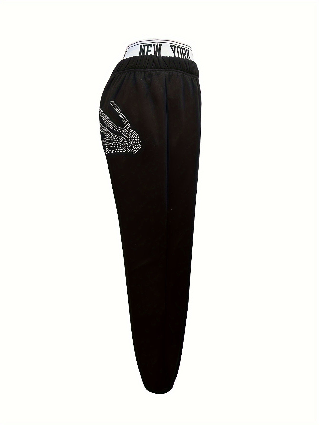 Women's casual jogger pants with elastic waistband, skeleton hands embellishment, and letter detail. All season knit joggers with cuffed ankles.