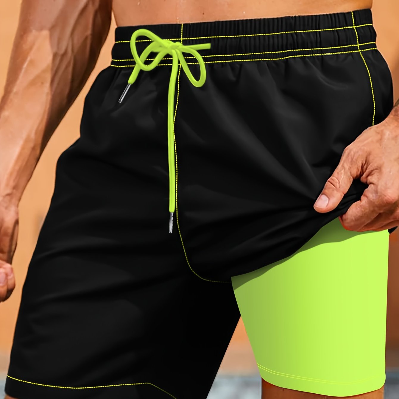 Men's black beach shorts with neon green accents, elastic waistband, polyester/spandex blend. Machine washable, plus size.