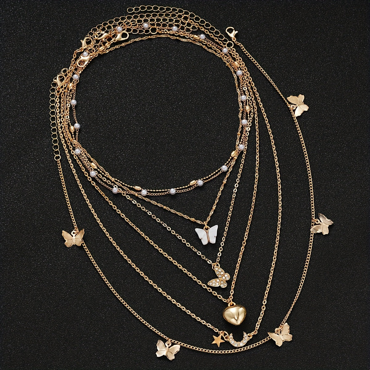 Set of 11 pieces featuring faux pearl and rhinestone star, butterfly, and heart necklaces for women. This fashion stacking jewelry set is perfect for daily wear, dates, holidays, and parties. Ideal for adding a simple and vacation style to any outfit.