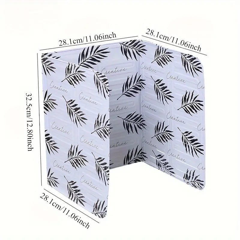 Kitchen stove baffle made of foldable aluminum foil featuring a tropical leaf pattern. This splash guard and cooking safety screen is perfect for deep frying and adding a touch of style to your kitchen decor. Use it as stove top protectors for added