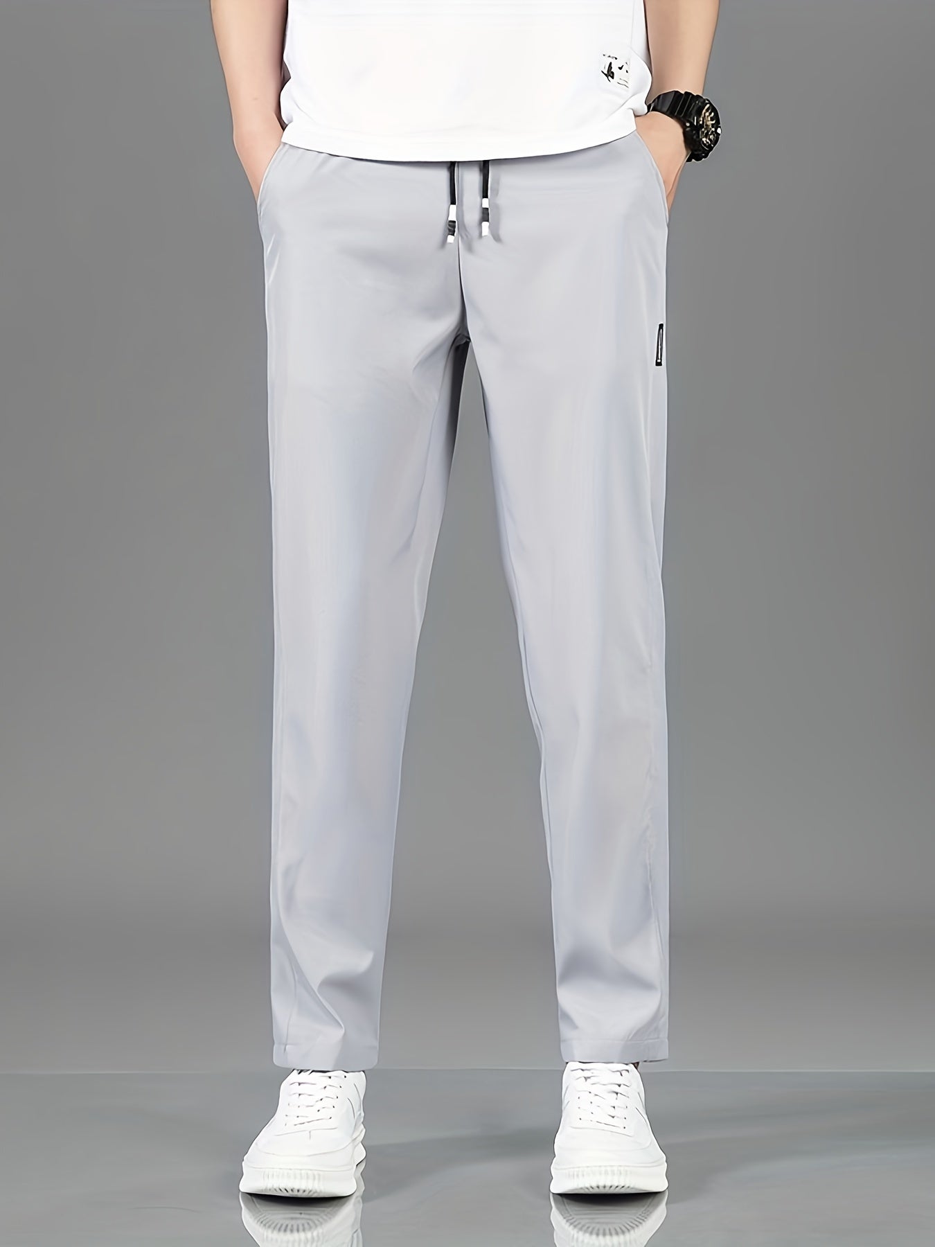 Men's casual straight-leg pants in solid color, made of non-stretch polyester and machine washable. Ideal for spring and fall.