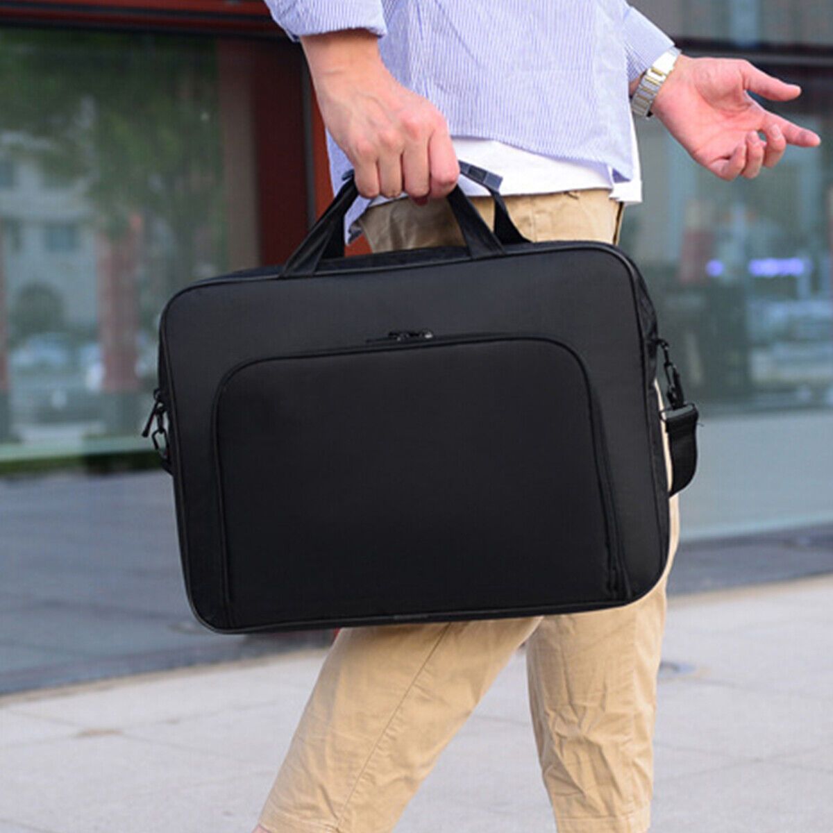 Durable black laptop sleeve with shoulder strap and compartments.