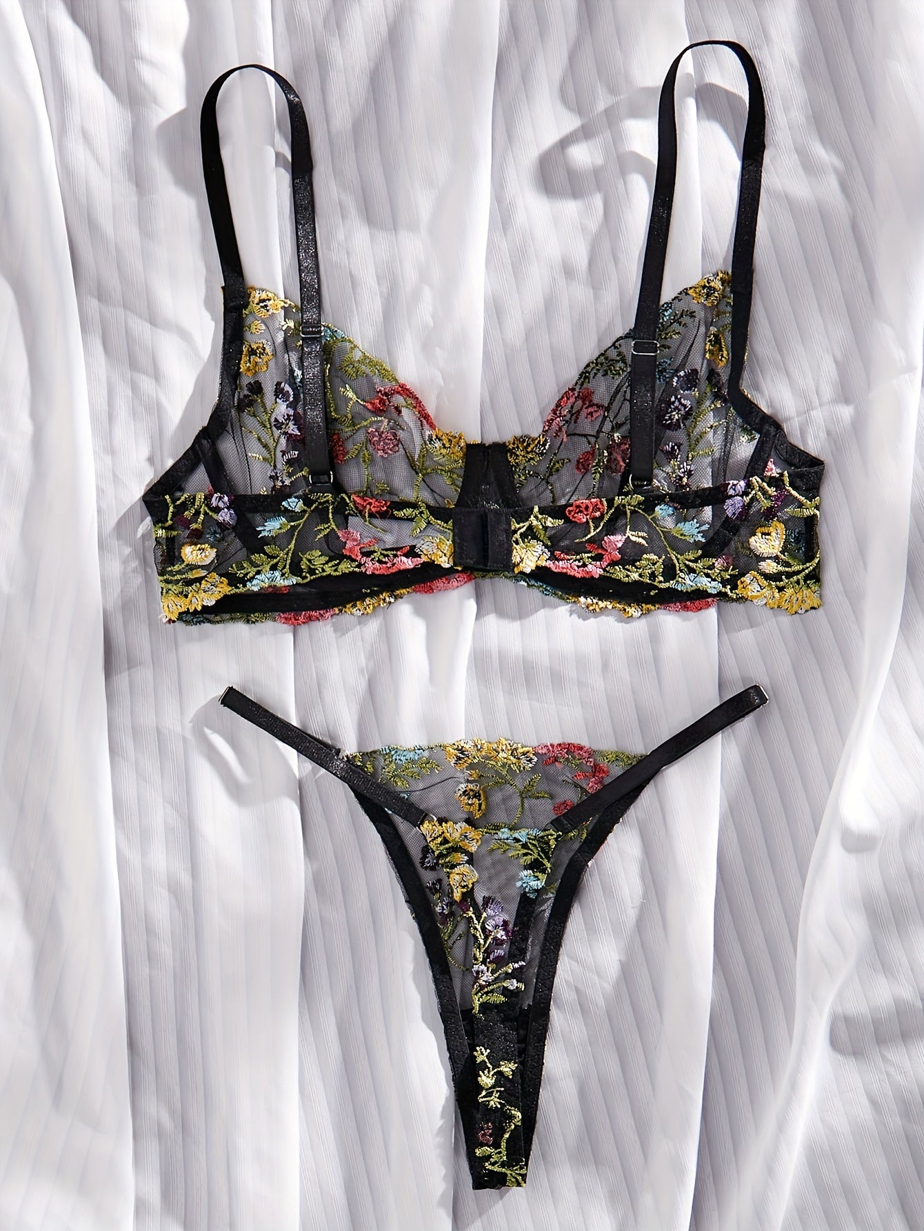 Floral embroidery underwear set with semi-transparent gathered bra and thong panties for a sexy and fresh look.