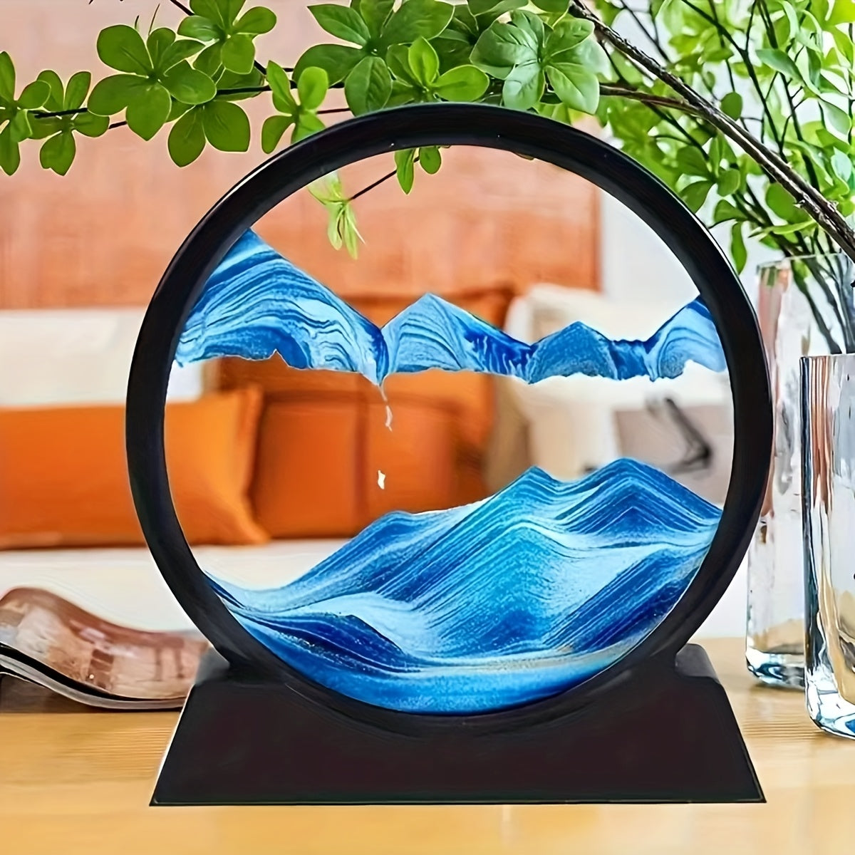 Large round glass frame with flowing sand creates a 3D deep sea scene as a relaxing home and office decoration.