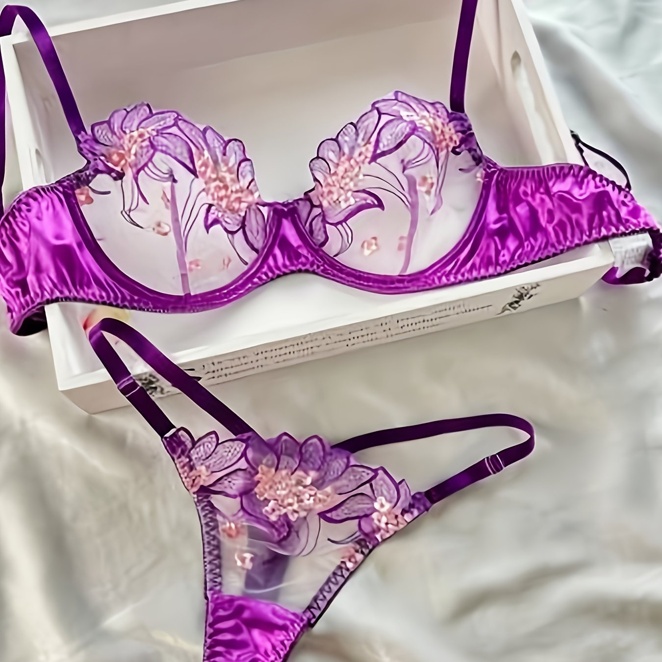 Floral embroidered sheer lingerie set with low cup non-padded bra and G-strings for women.