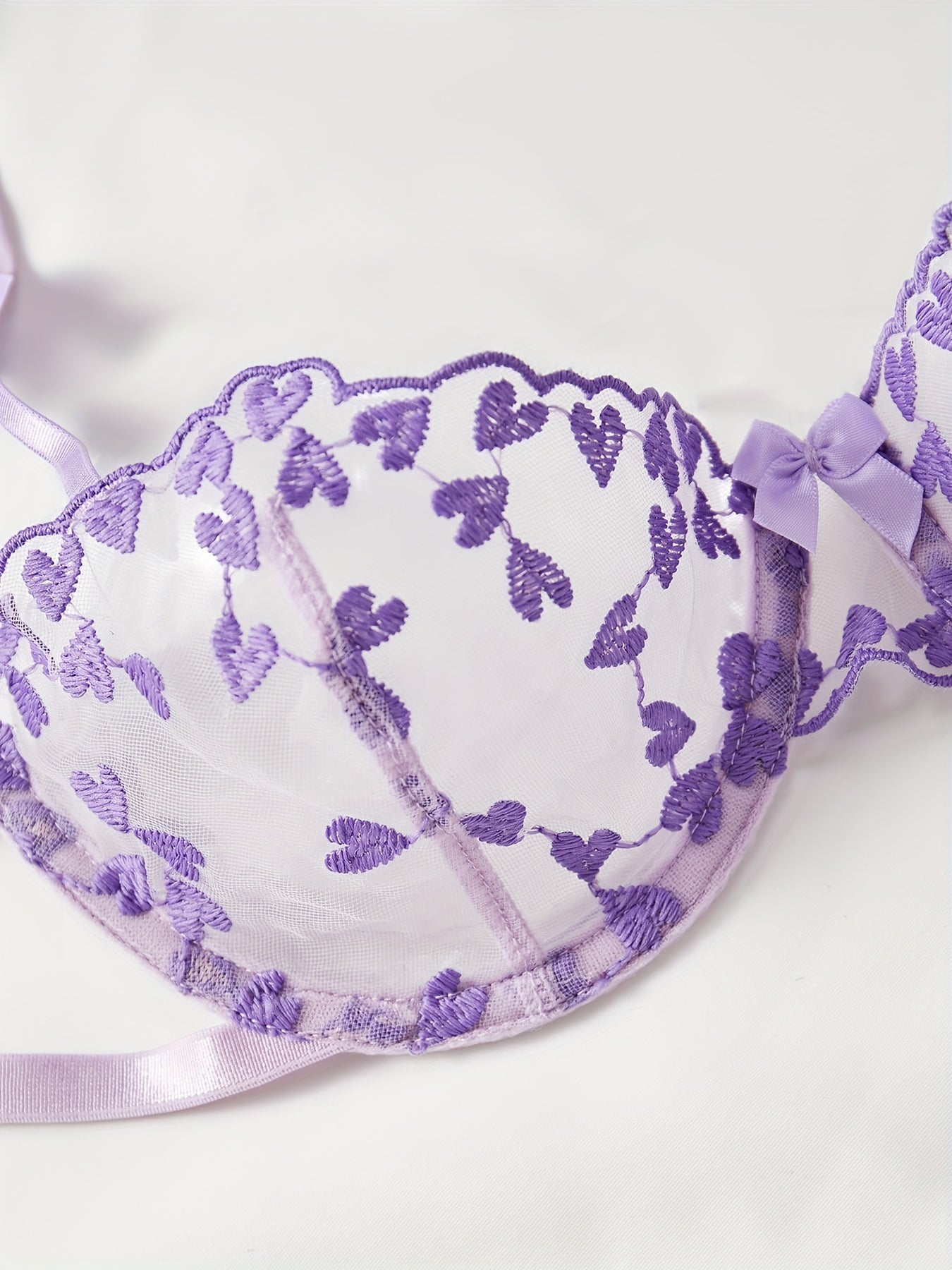 Purple mesh lingerie set with heart embroidery, bow decor, semi-sheer bra and tie side thong. Women's sexy underwear.