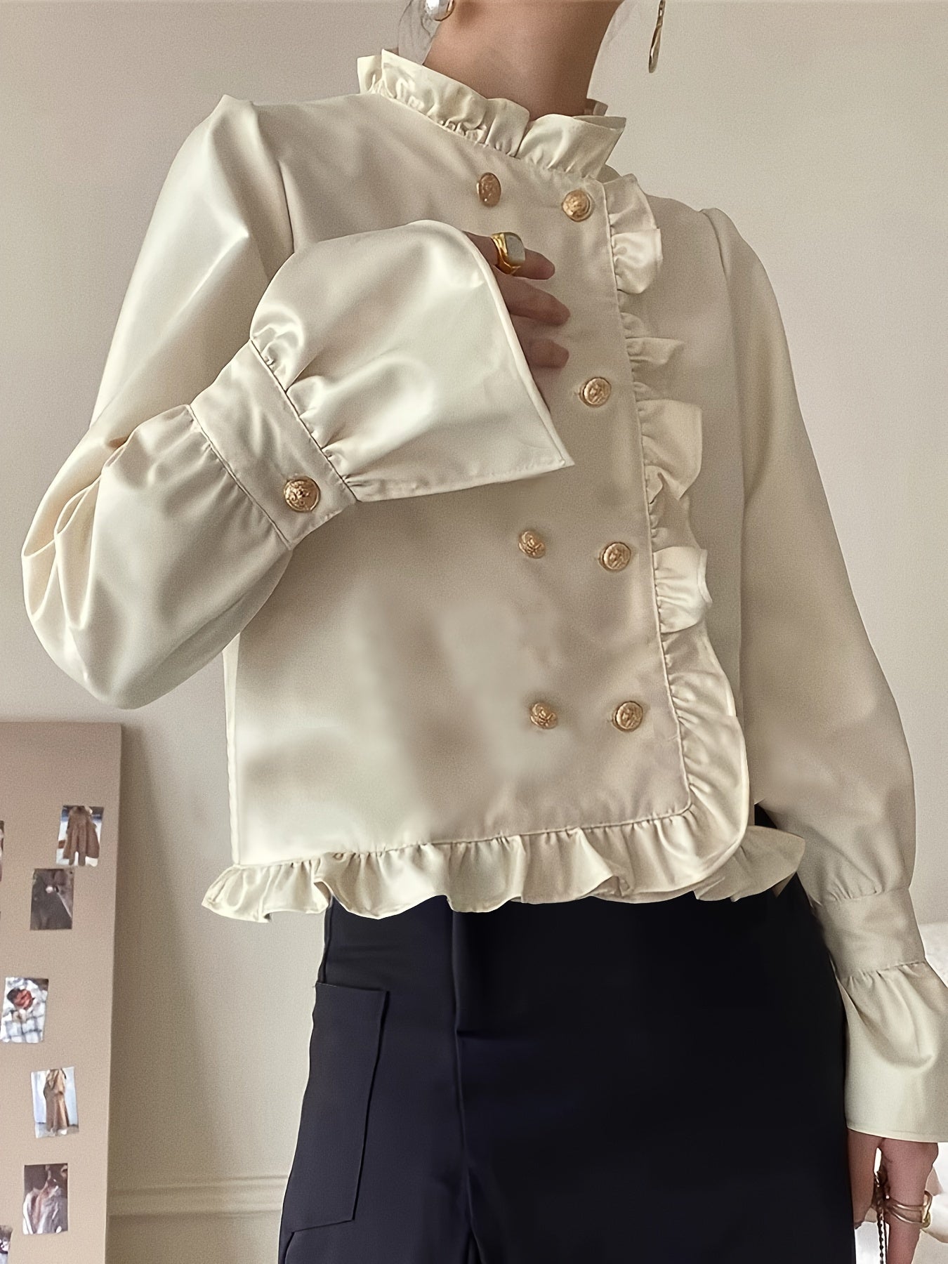 Stylish cream blouse with ruffle trim and stand collar for fashionable women.