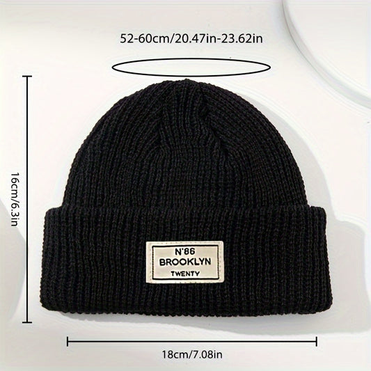 Stylish knit beanie for teens with trendy label design, machine washable.