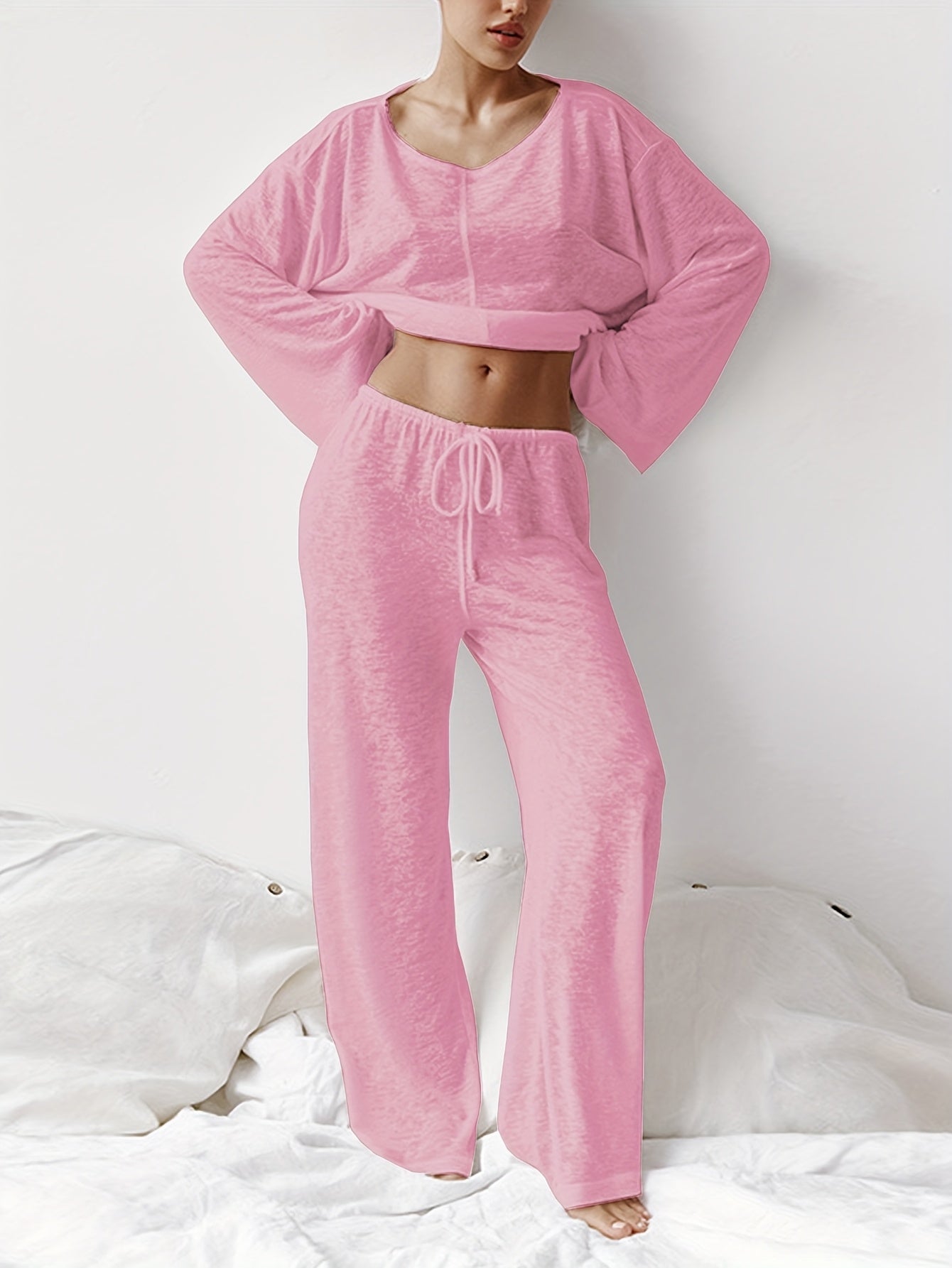 Two-piece set of loose home clothes for women made with micro-transparent fabric featuring a round neck, long sleeves, and trousers.