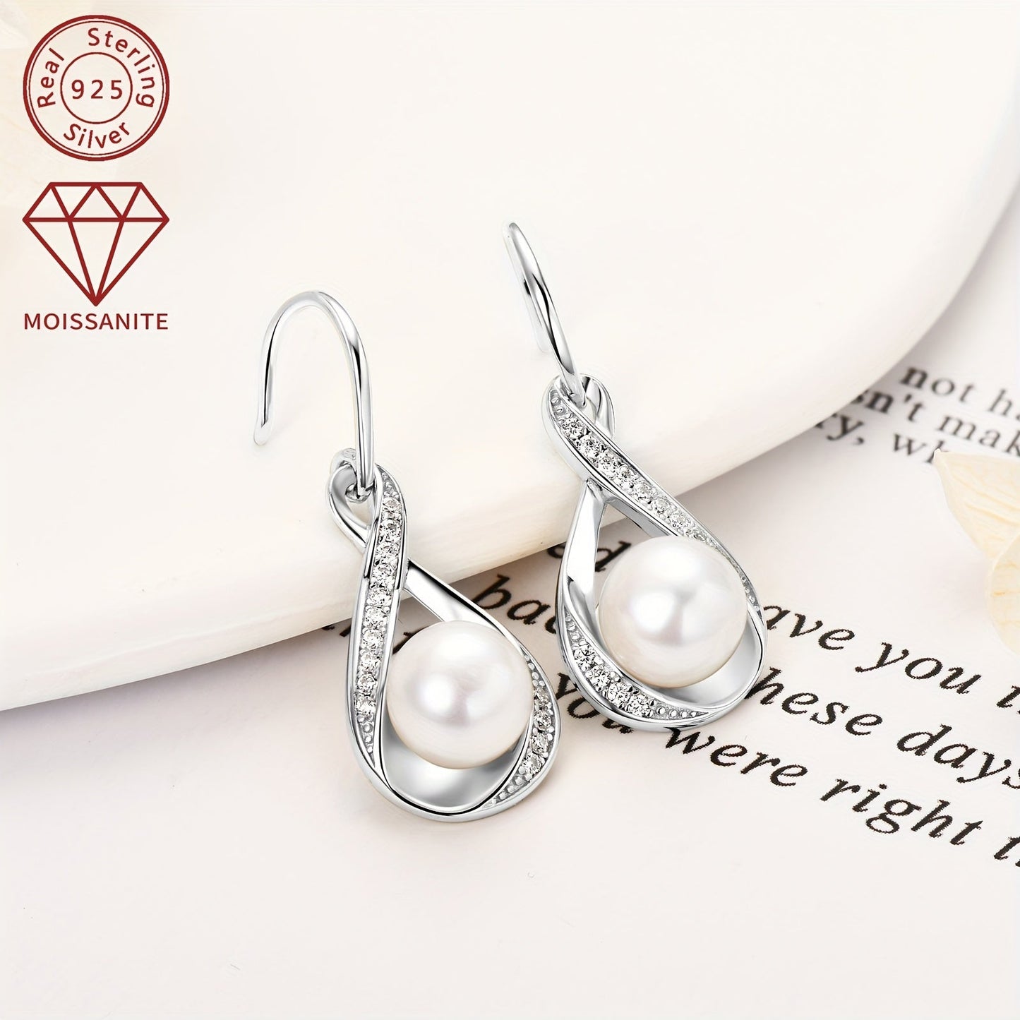 Pair of pearl earrings featuring natural freshwater bread beads measuring 8mm and adorned with 28 pieces of 1.2mm moissanite stones, totaling 0.224 carats. Crafted in 925 silver, these earrings boast a silvery gram weight of 3.7g. The design showcases a