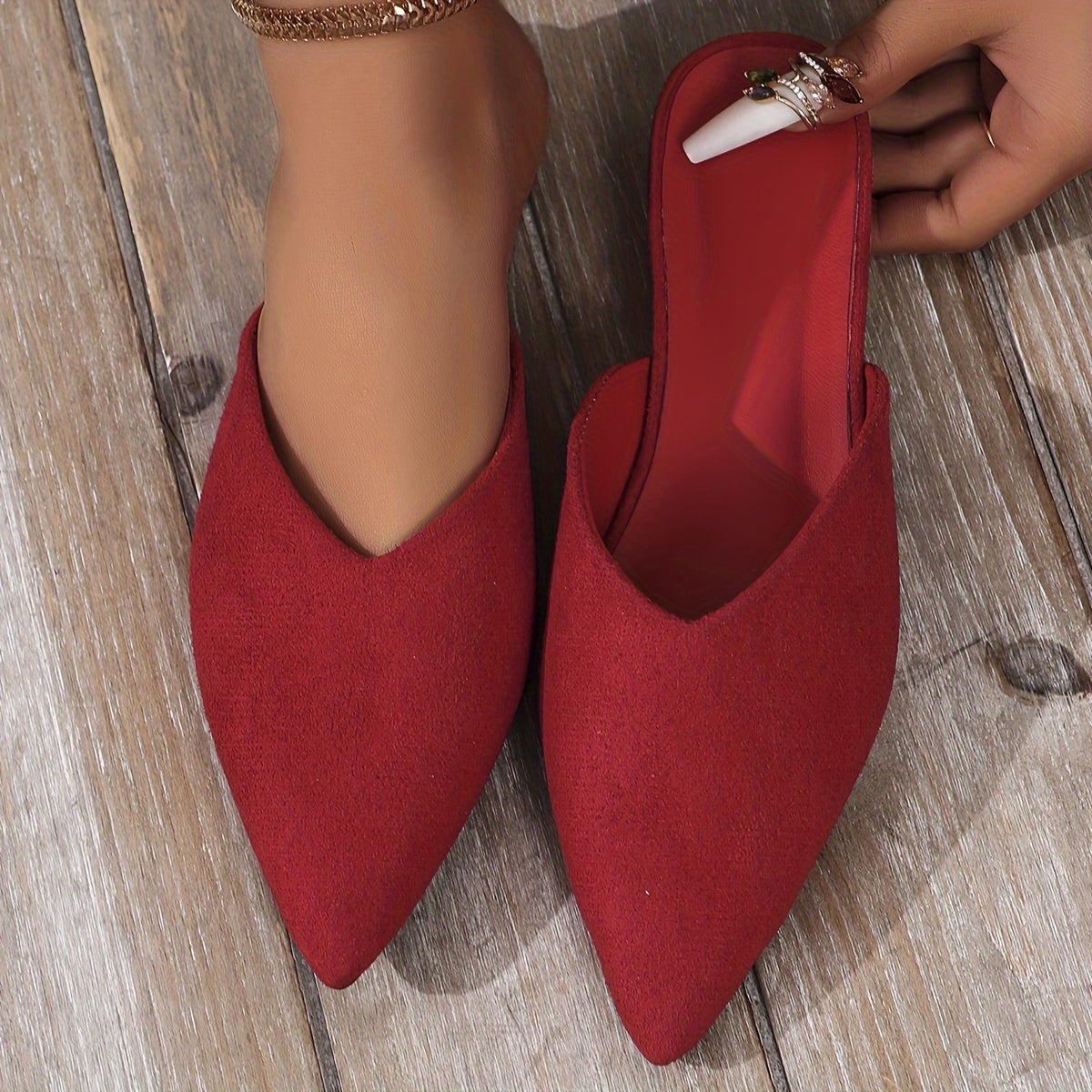 Stylish orange flat mules for women in plus sizes with pointed toe and slip-on design, perfect for casual wear.