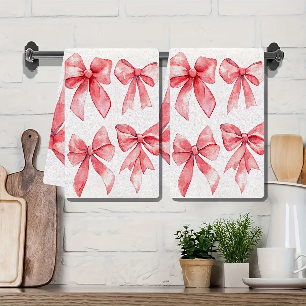 Two ultra soft kitchen towels featuring a Valentine's Day bows design. These towels are highly absorbent, machine washable, and measure 40.64x60.96 cm. The contemporary red bow pattern is perfect for holiday decor.