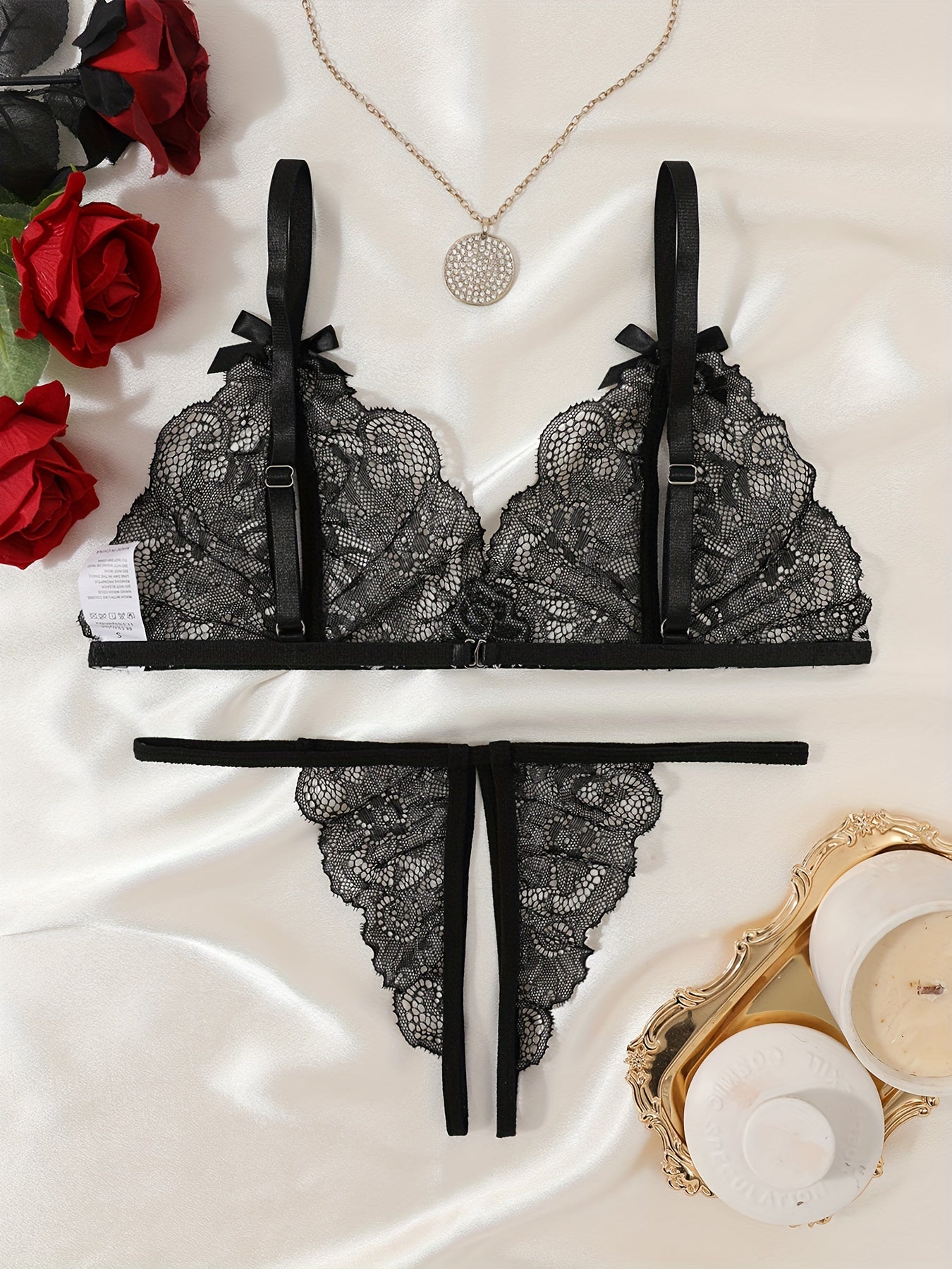 Floral lace lingerie set with cupless bralette, bow detail, crotchless thong panty, and intimate boudoir wear.