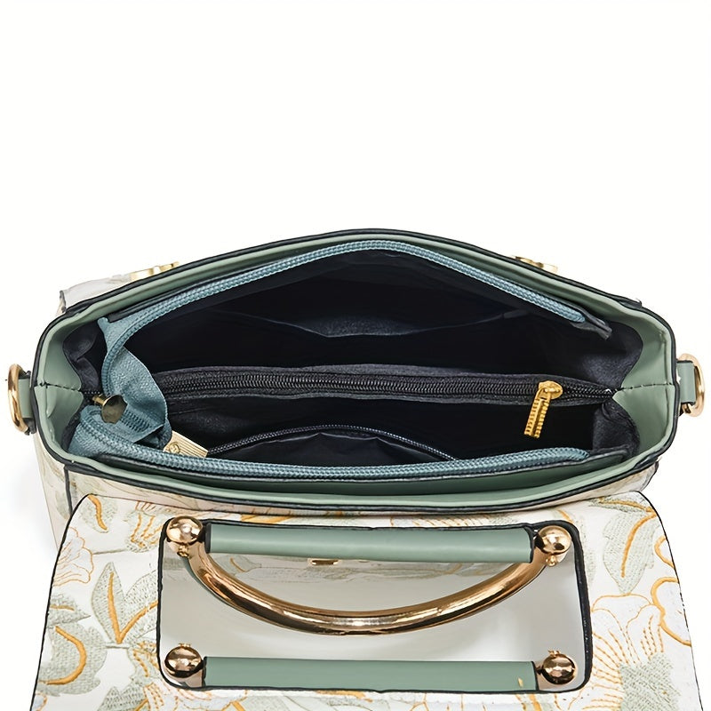 Large capacity floral embroidered crossbody bag with zipper closure and polyester lining. Versatile commuter handbag with luxurious, fashionable design and edge paint detail. Available in