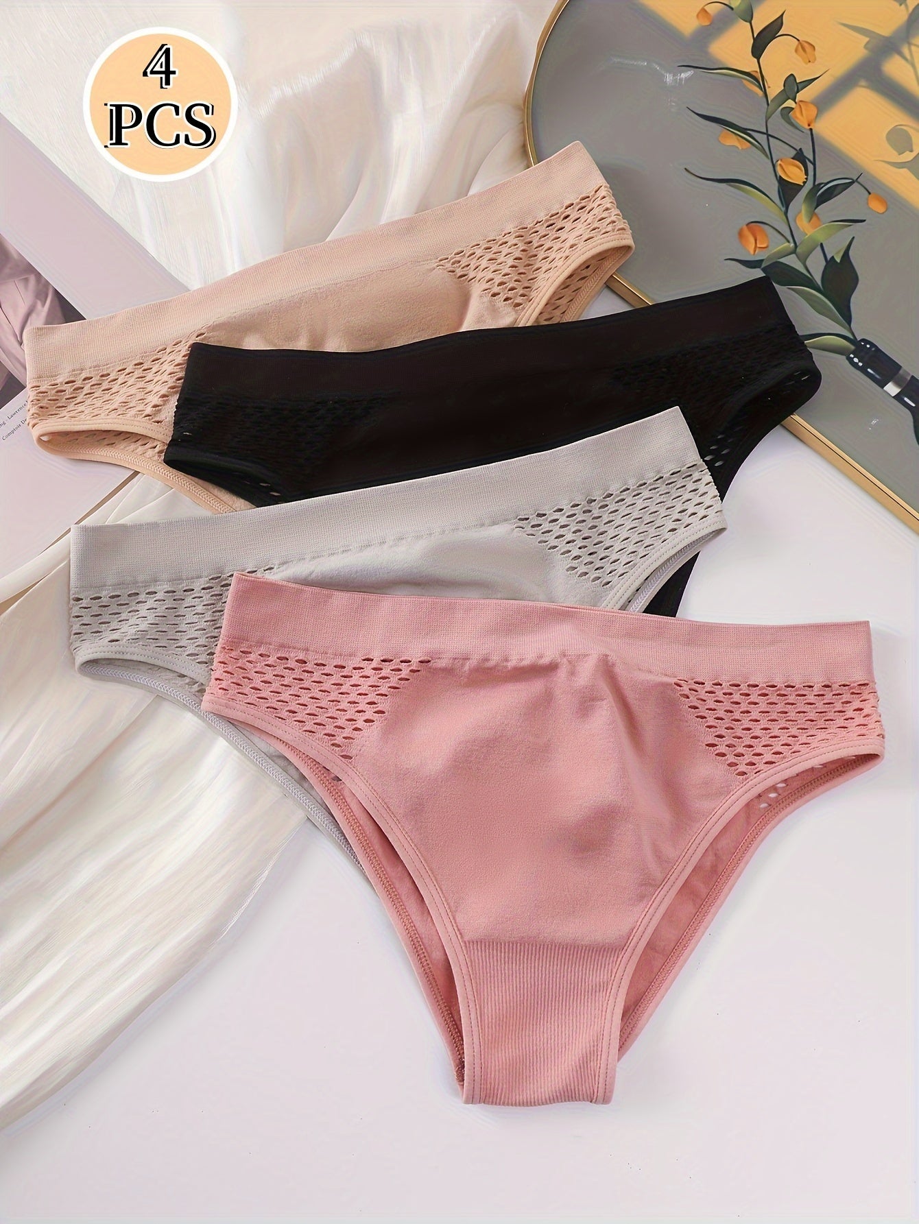 Four-pack of low-rise briefs for women, with hollow-out design and medium support. Made from a blend of 90% Polyamide and 10% Elastane knit fabric, in a solid color. Lightweight at 200gsm