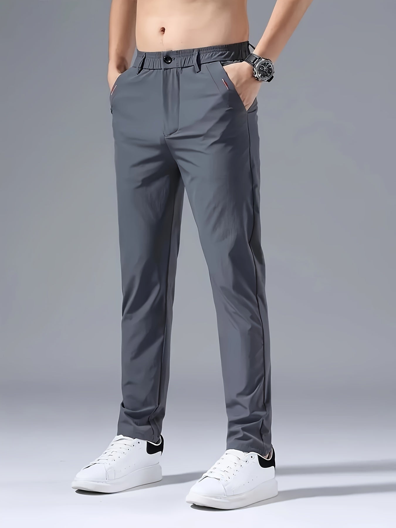 Men's slim fit casual pants made of breathable nylon fabric with pockets and embroidery. Suitable for outdoor and daily wear in a solid color basic style. Features zippered waist for