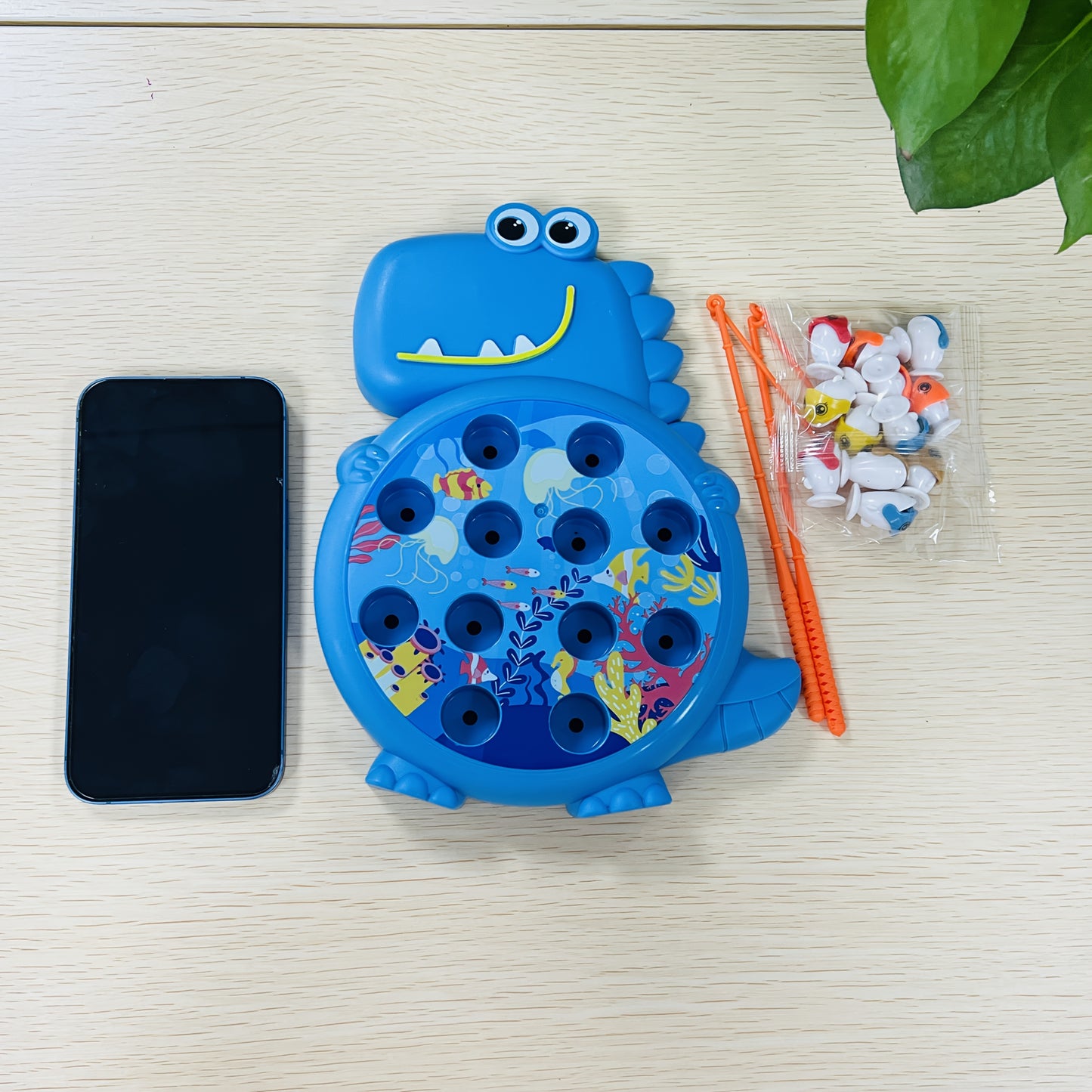 Dinosaur fishing plate toy with weak magnetic rod, suction hook, small fish, plastic material, in green/blue color.