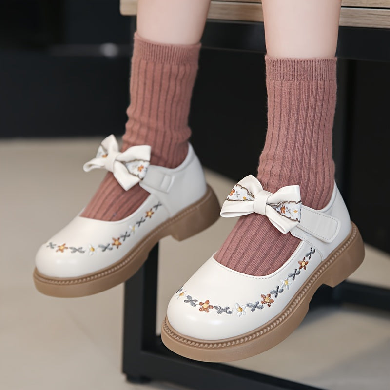 Girls' Mary Jane shoes for Fall 2024, featuring an elegant princess style with floral embroidery and bow detail. Non-slip rubber sole, hook-and-loop strap closure for school, parties, or