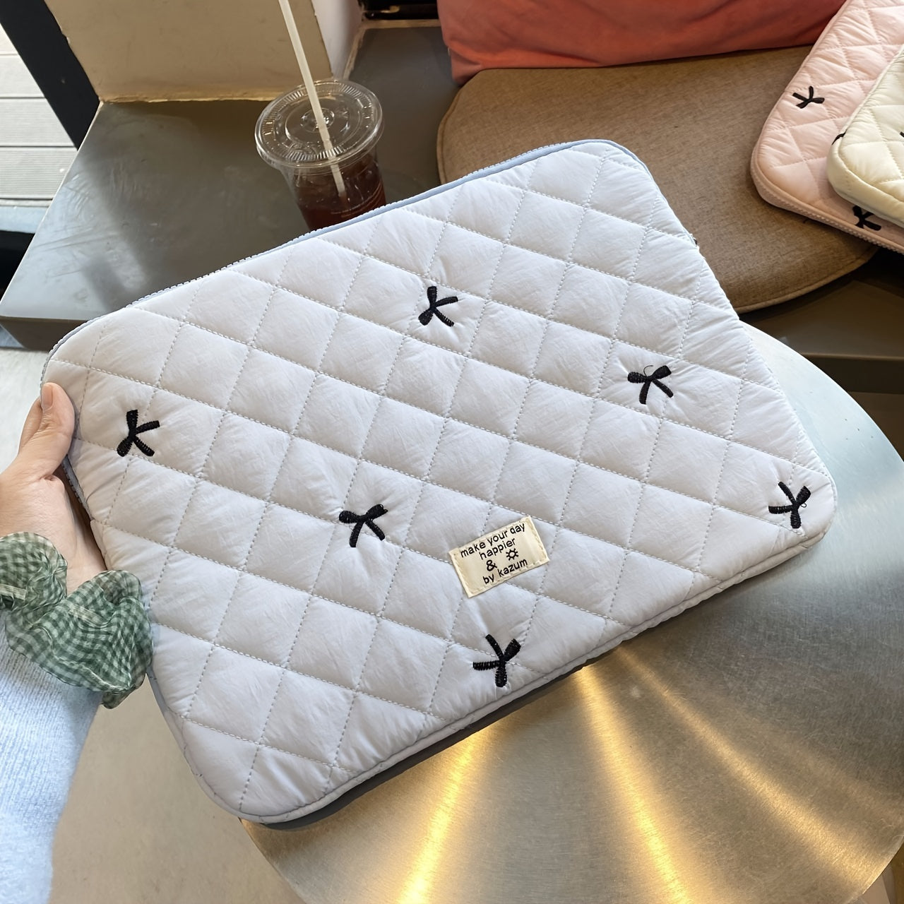 One laptop bag with ballet style bow embroidery, suitable for various devices.