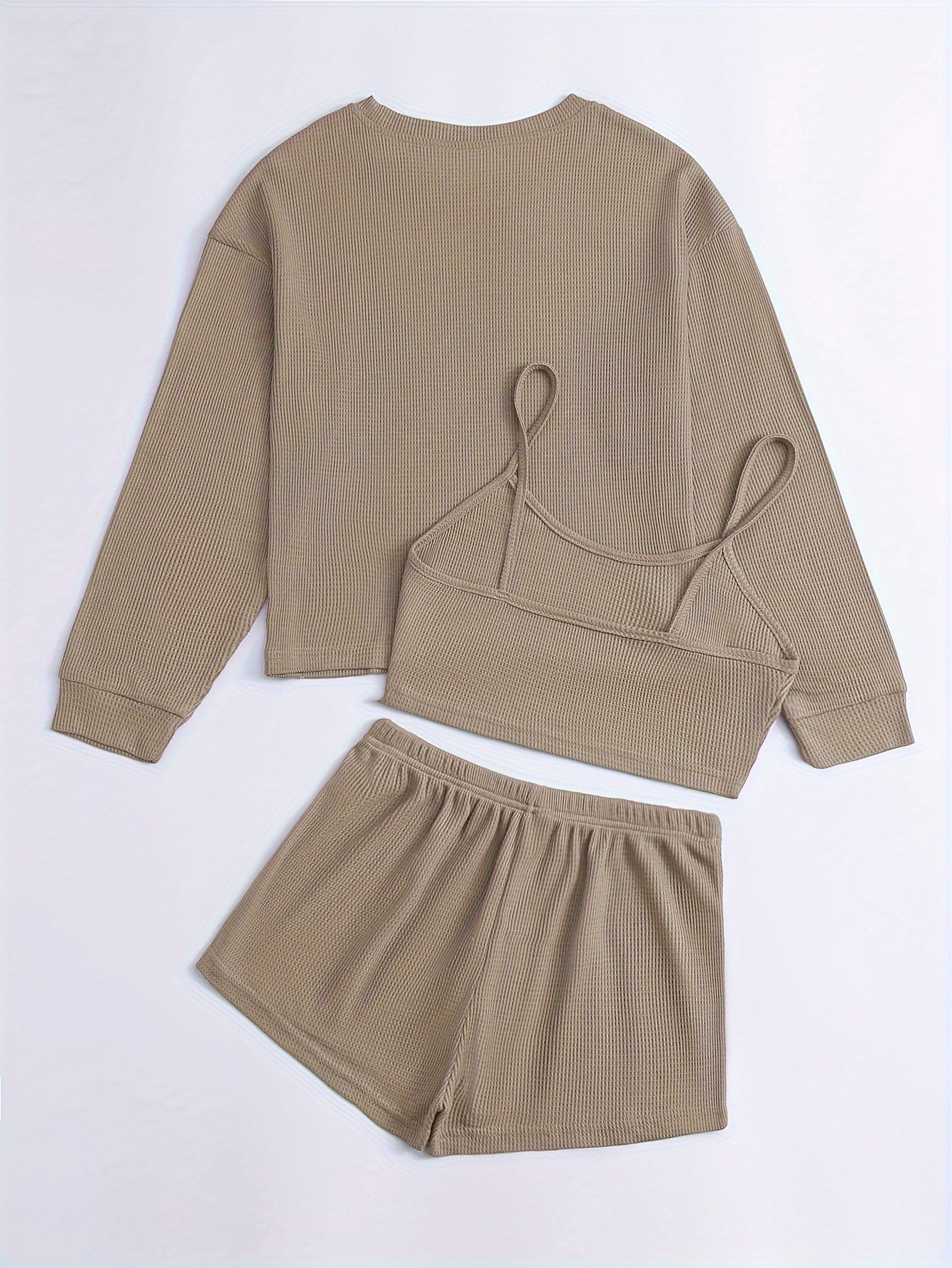 Women's loungewear set with waffle texture, long sleeve top, crop cami, and elastic shorts.