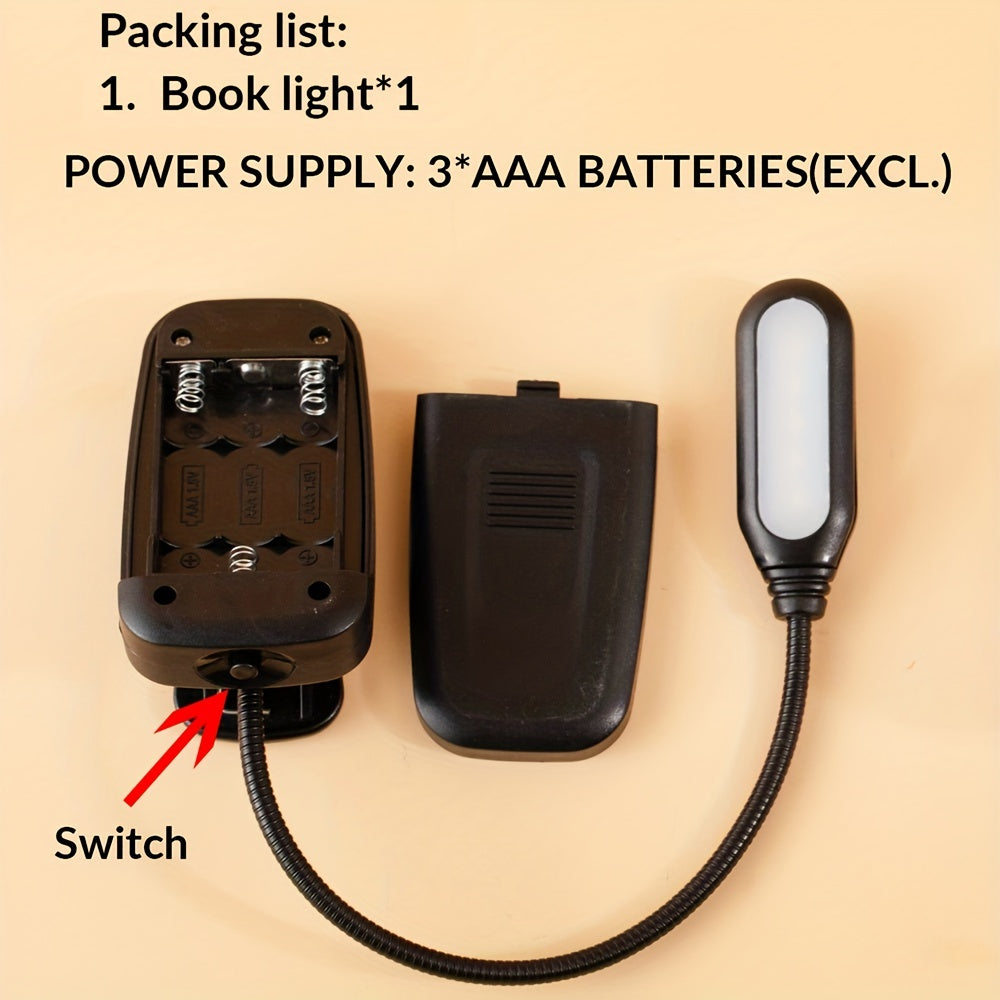 Portable battery-powered space-themed book light with adjustable arm, push button control, and uplight lighting, ideal for bedside use.