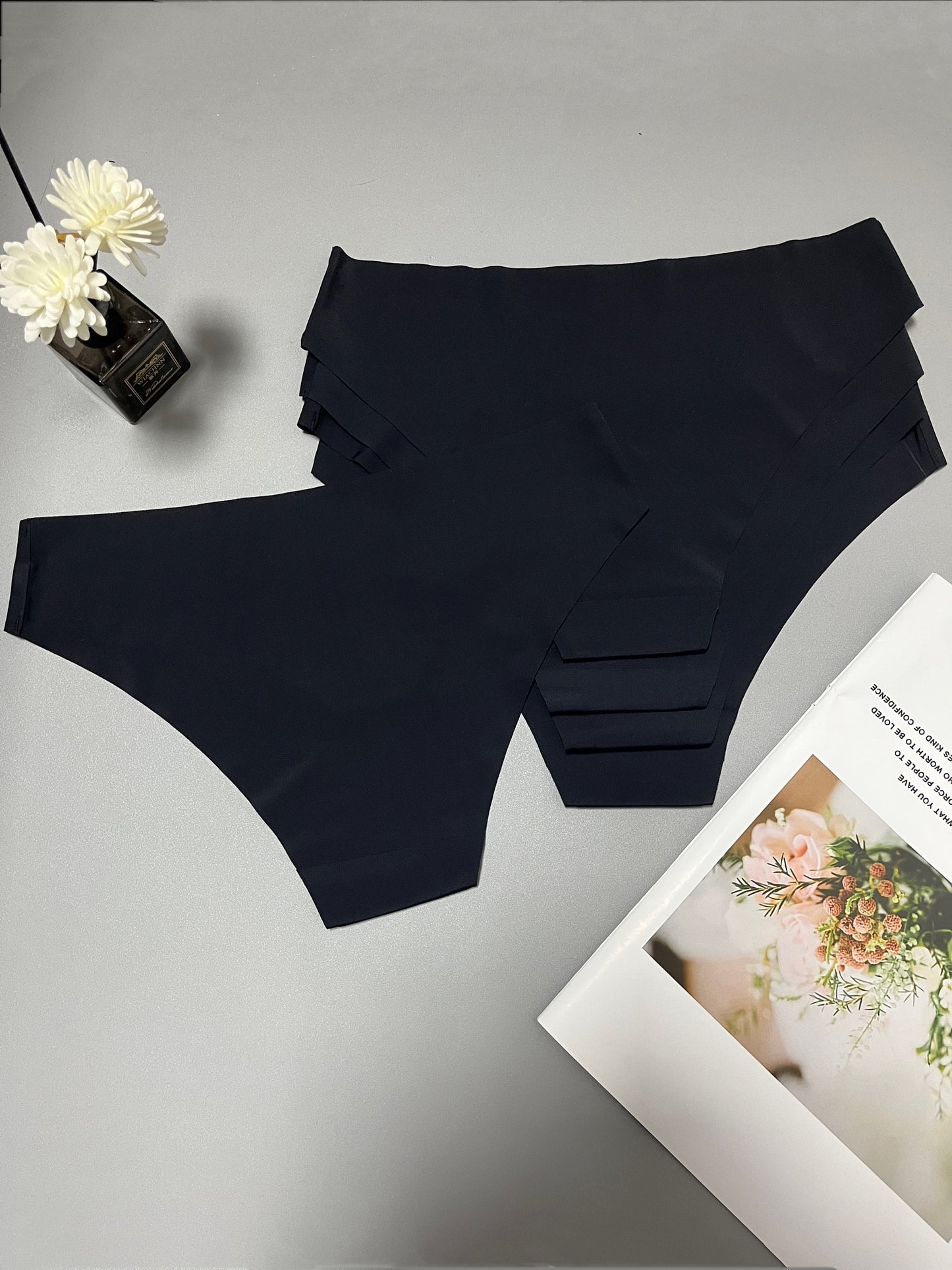 Women's black seamless briefs, low-rise, hand washable, stretchy and breathable nylon/elastane blend.