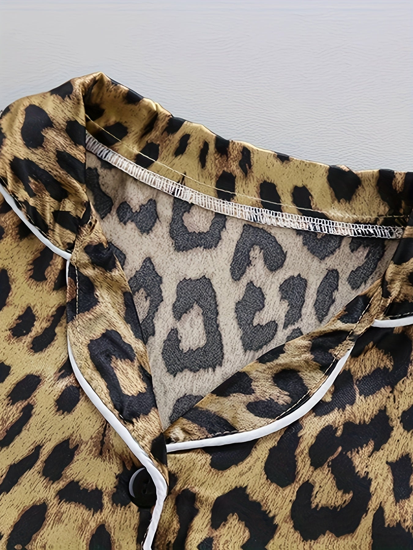 Comfortable leopard print pajamas with front buttons, long sleeves, elastic waistband, and long pants for home wear.