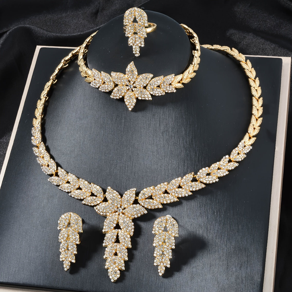 Get the ZEADEAR Luxury Elegant Flower Theme Jewelry Set for Weddings and Special Occasions, featuring high-quality -Plated Copper and Sparkling zirconia. This stunning set includes 1 Necklace, 1 Bracelet, 1 Ring, and 1 Pair of Earrings.