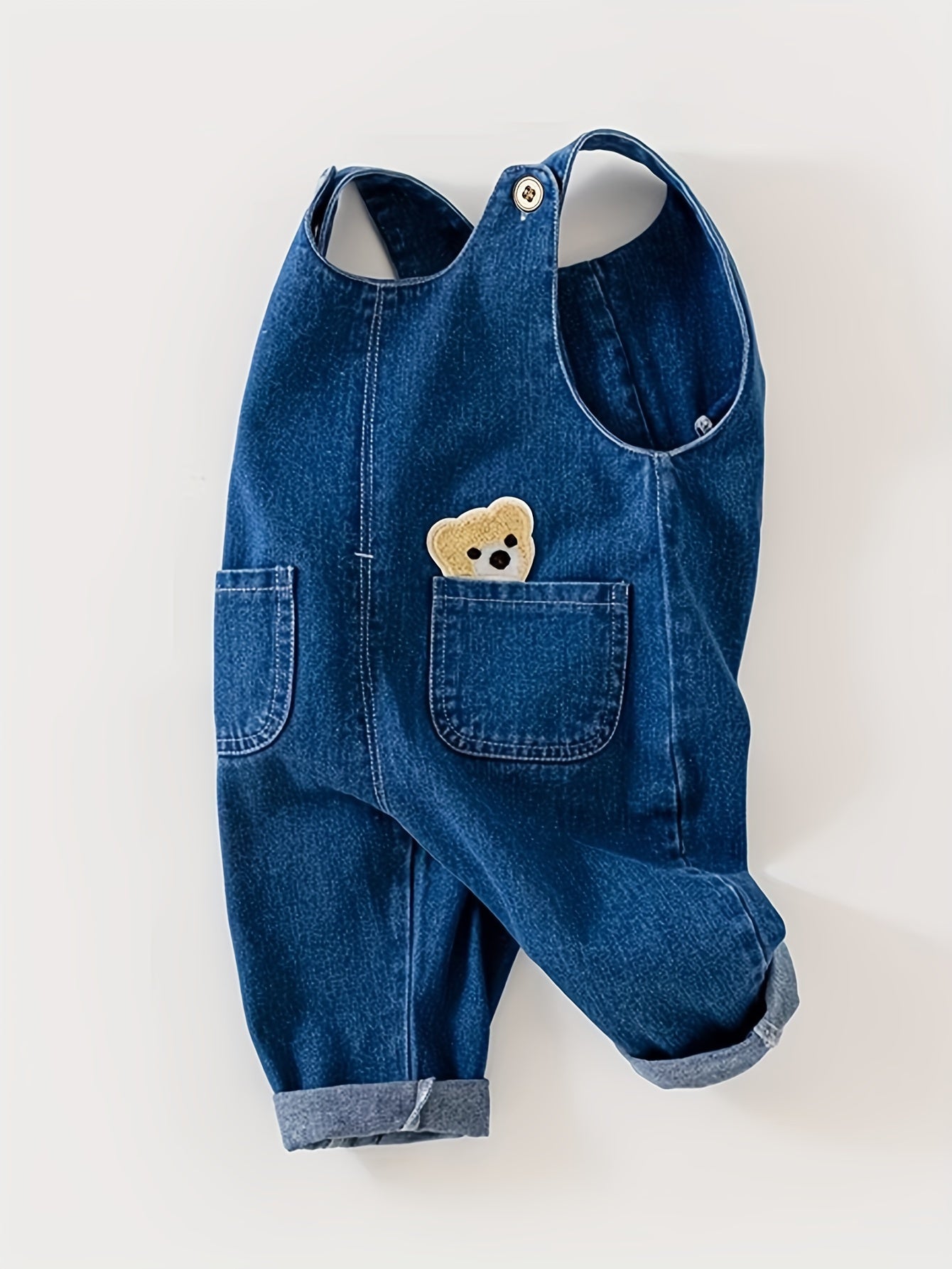 Children's denim overalls with animal pocket detail, made from a cotton blend fabric. Ideal for spring and fall seasons, this unisex toddler jeans romper is perfect for outdoor play.