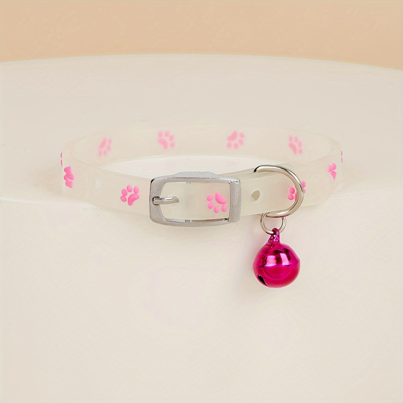 Adjustable glow-in-the-dark cat collar with colorful paw print for easy spotting at night.