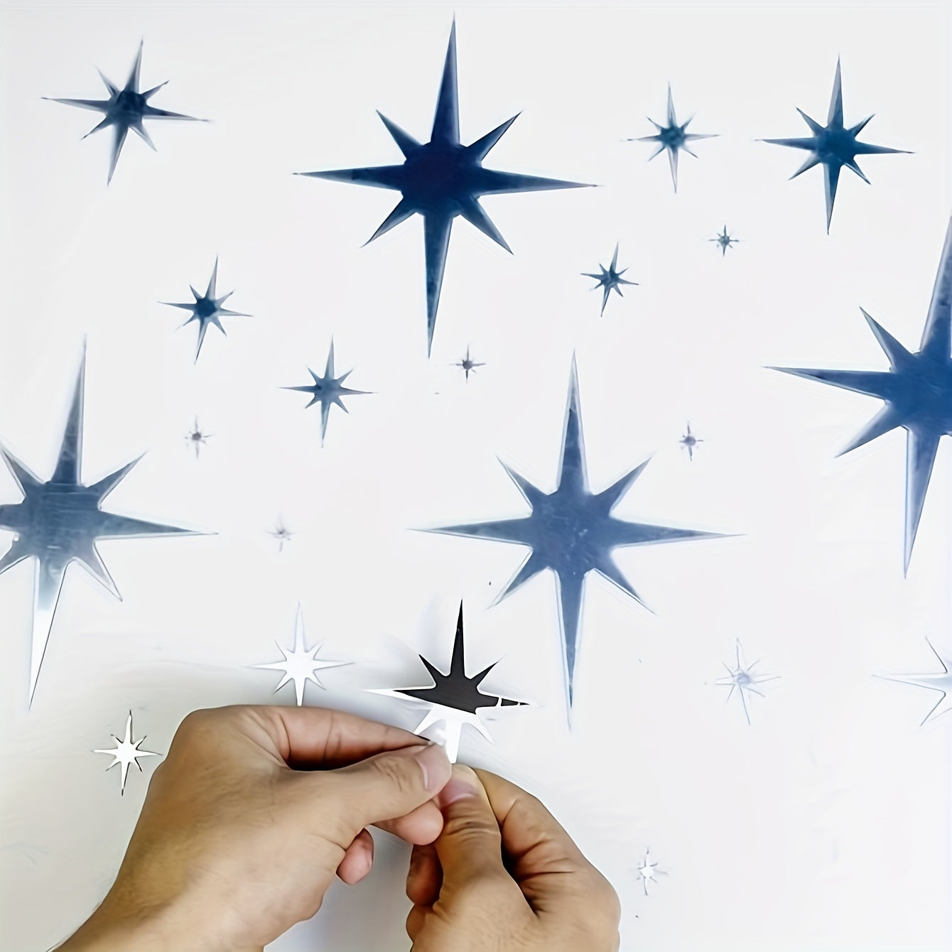 Box of 82 acrylic star mirror stickers for creative wall and ceiling decor.