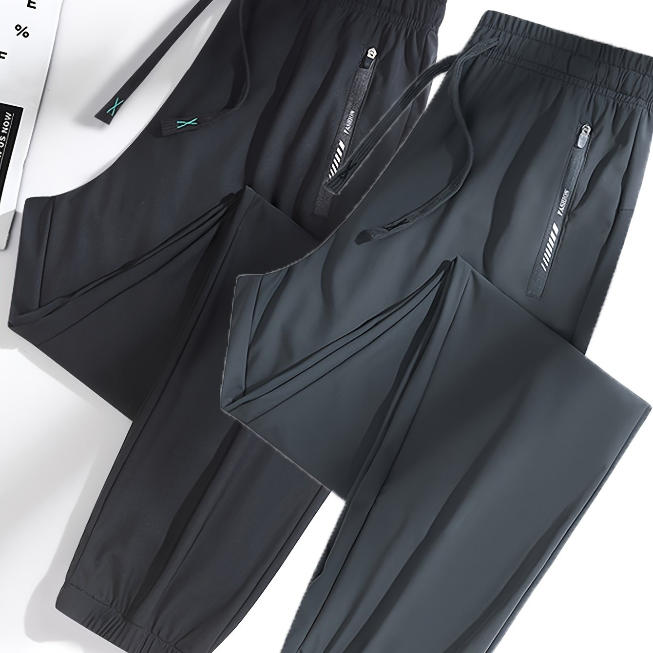 Pair of women's summer sports long pants with elastic waist and zipper pockets, stylish tapered joggers.