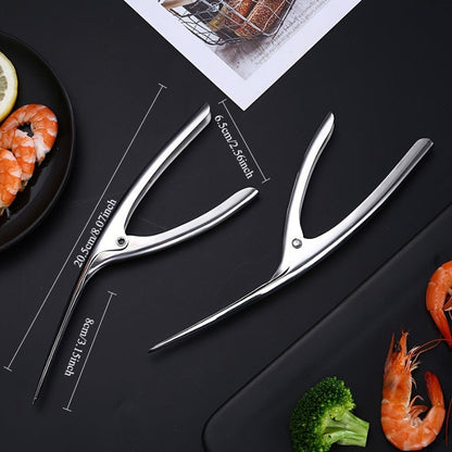 Effortlessly remove shrimp shells with this stainless steel deveiner peeler featuring a comfort grip handle. This kitchen utensil is designed for easy shrimp preparation and is made with food contact safe material.