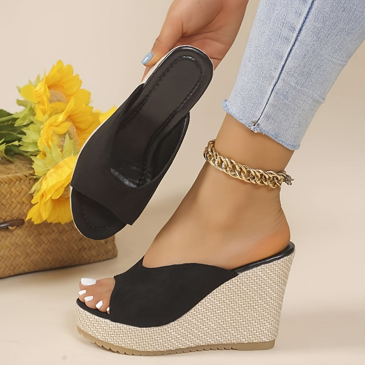 Black slip-on wedge sandals for women with an open toe, high heel, comfortable ankle strap, and woven design sole - perfect for casual summer wear.