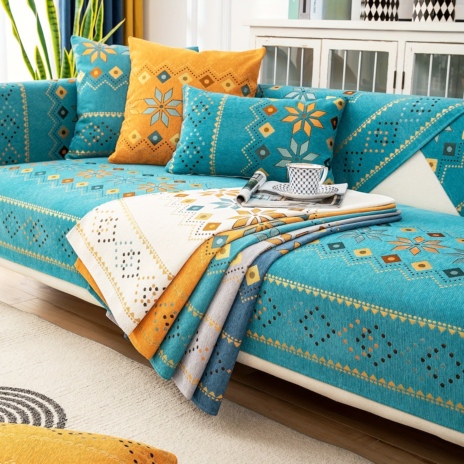 Bohemian chenille sofa cover with geometric embroidery in teal, orange, and yellow. Pet-friendly, non-slip, and durable. Fits all sofa sizes from single to four-seater. Machine washable. Adds a pop of color to your living room decor.