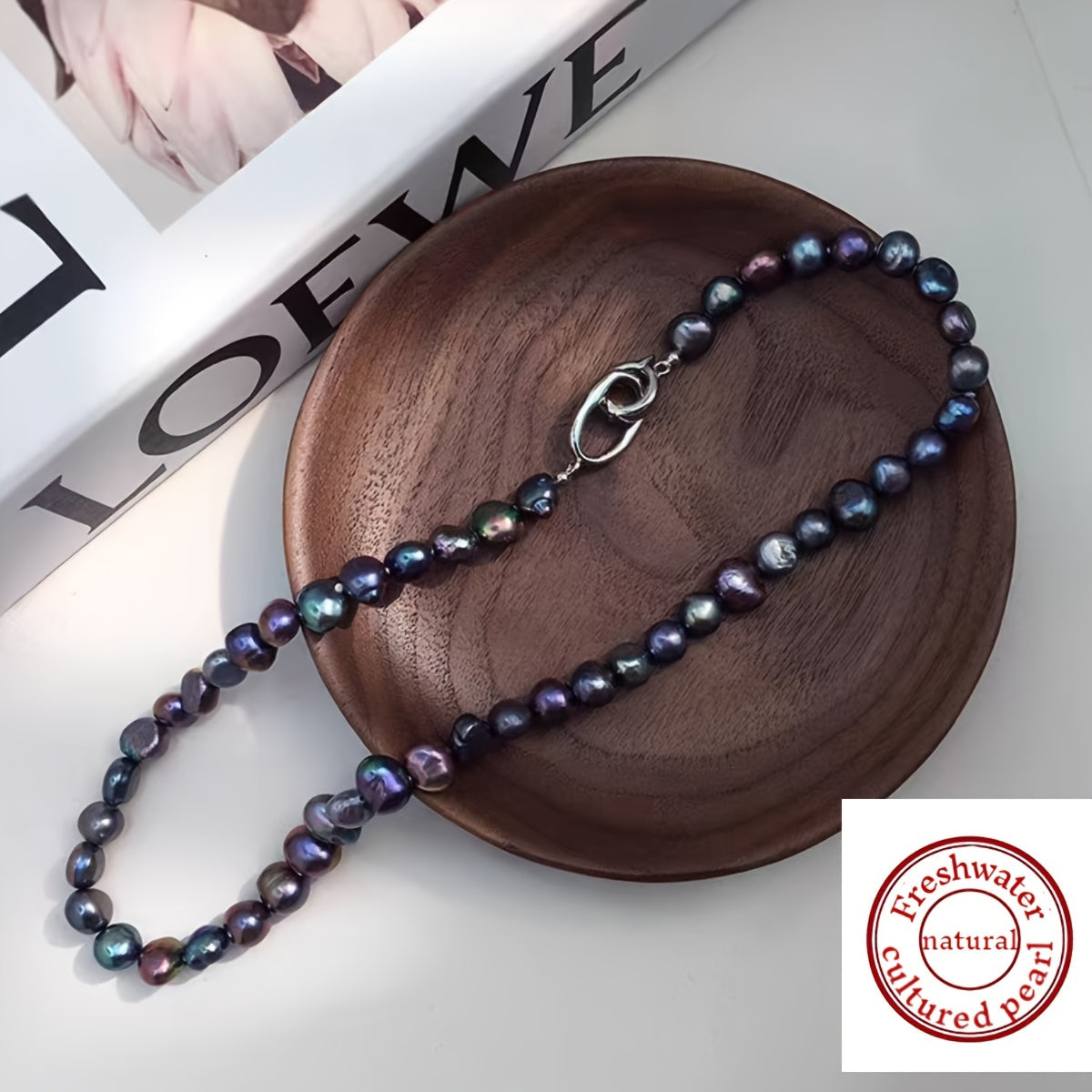 This necklace features a beautiful, natural freshwater cultured pearl measuring 7-9MM in a stunning blue-black hue. The clavicle length necklace is designed for women and showcases irregular baroque pearls with a unique texture and shape. Each pearl is