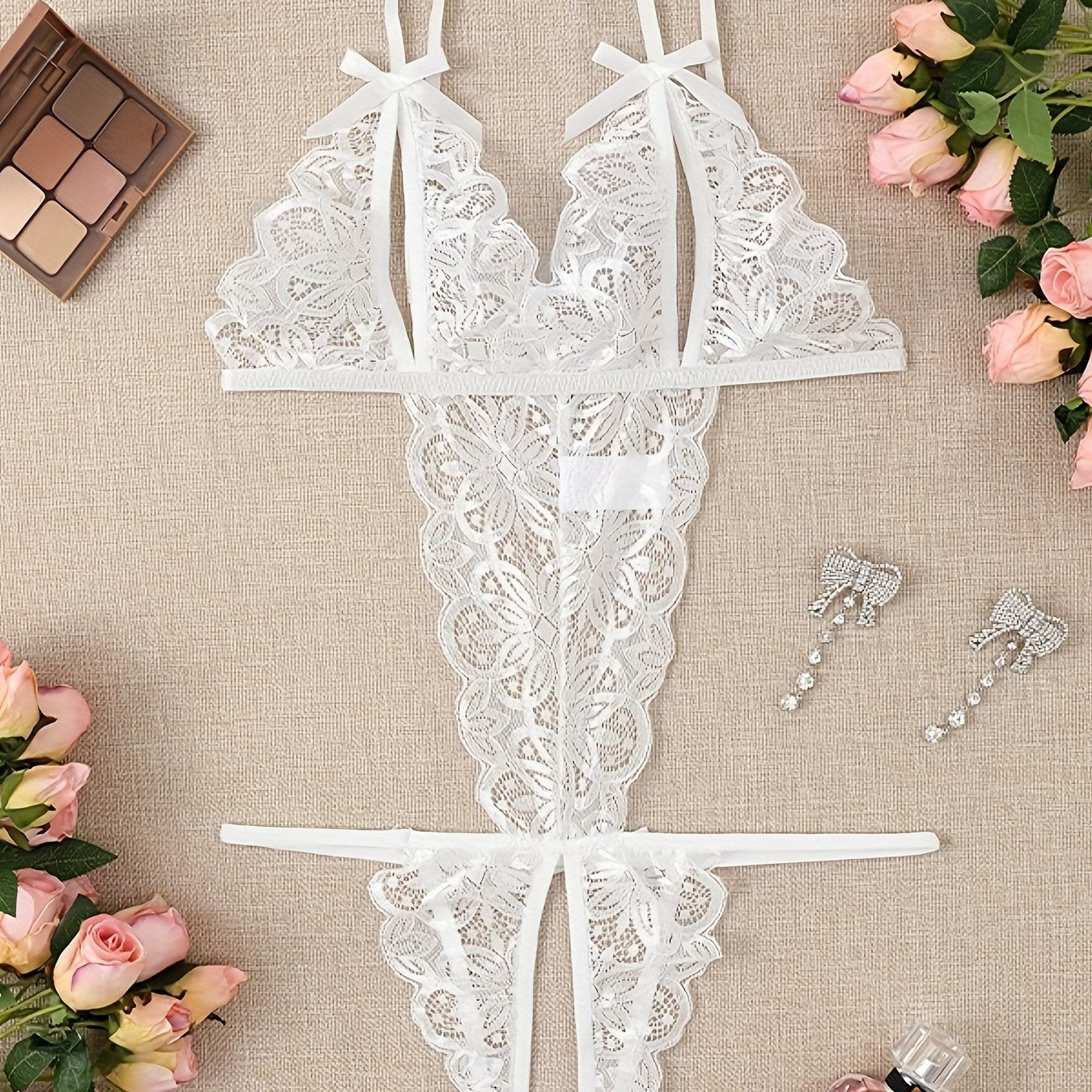 Women's open-crotch backless lingerie set with lace detailing.