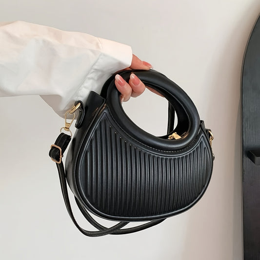 Chic black crossbody bag with embossed stripe pattern and golden-tone hardware, versatile for everyday use with a luxury look.