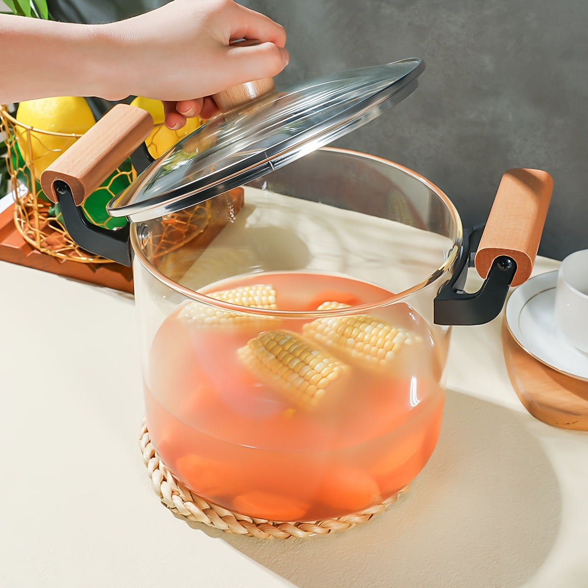 Glass saucepan with lid, 4.5L capacity perfect for noodles, soup, and milk. Made of high borosilicate material with dual wooden handles. Compatible with gas stovetop and features a transparent design for easy cooking. Ideal addition to any kitchen.