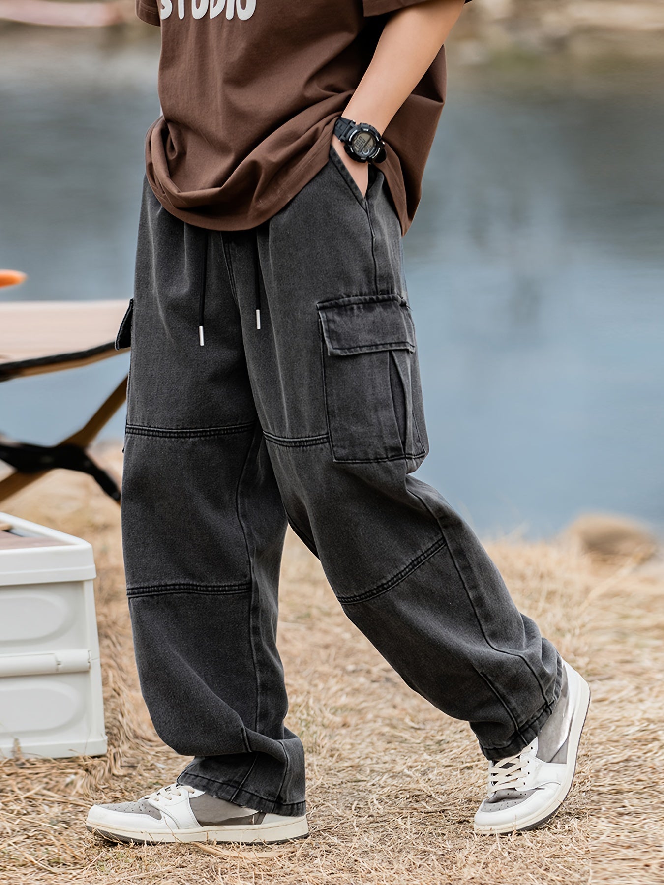 Men's cargo pants with multiple pockets and drawstring, ideal for outdoor activities in spring and fall.