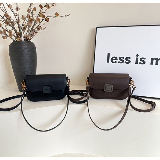 Stylish black crossbody bag with zip closure, made of durable PU material, inspired by retro design.