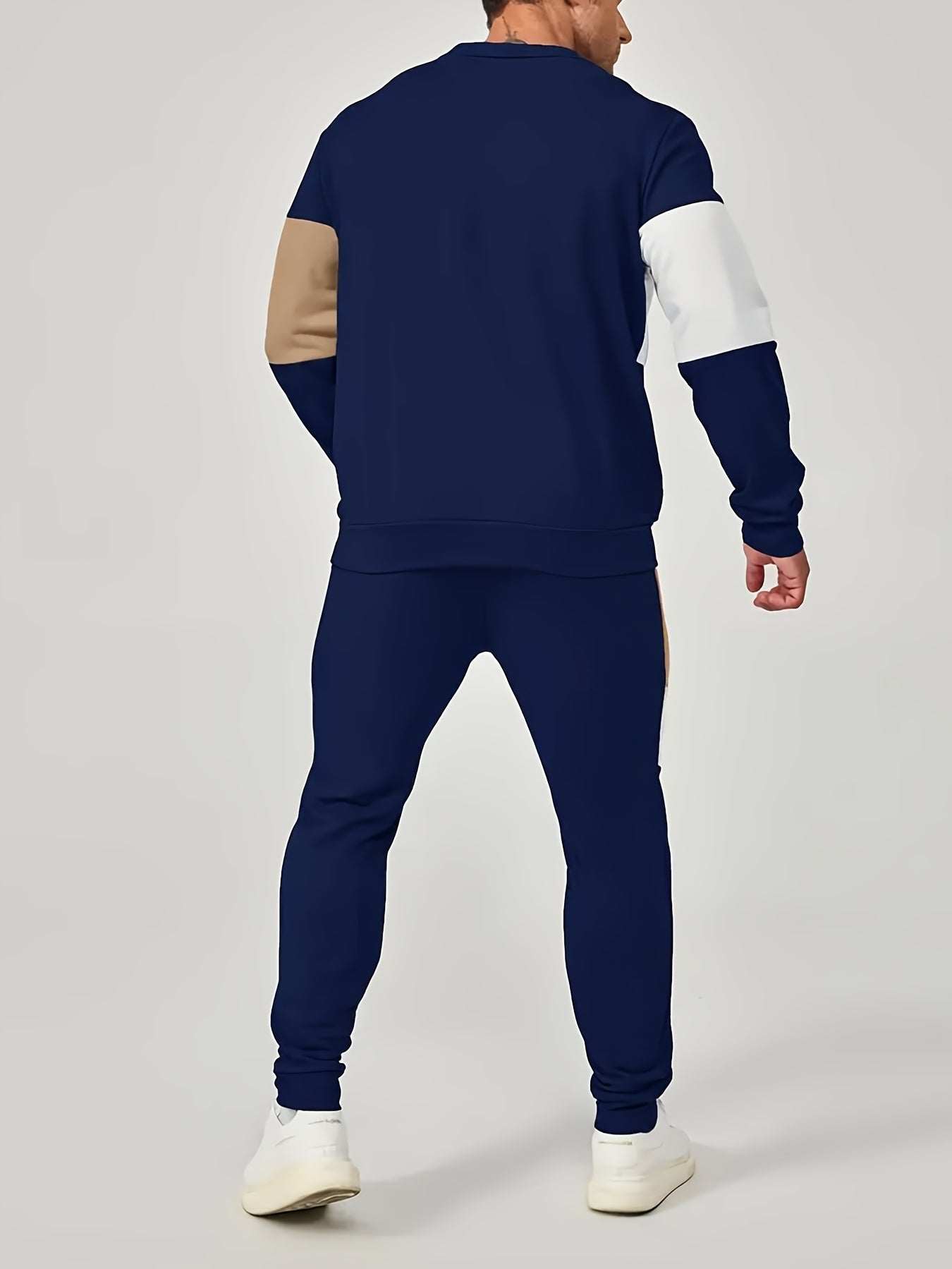 Casual men's outfit includes color block sweatshirt and drawstring pants.