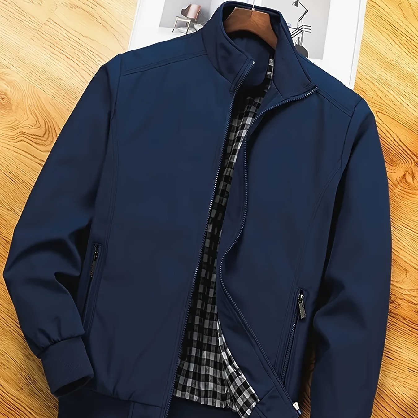 Men's casual spring/autumn polyester jacket with stand collar, zipper pockets, and solid long sleeves for outdoor and workwear.