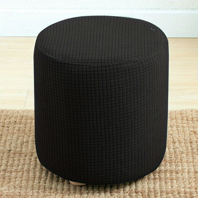 Stretchable round footstool cover made from soft polyester blend with elastic fit. Available in multiple colors, machine washable, modern design for living room ottomans.