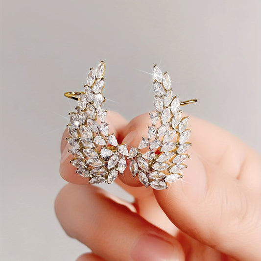 Chic and minimalist, these ear clips feature a golden leaf design with sparkling zirconia inlays. This fashionable accessory is perfect for everyday wear and makes a great gift for women.