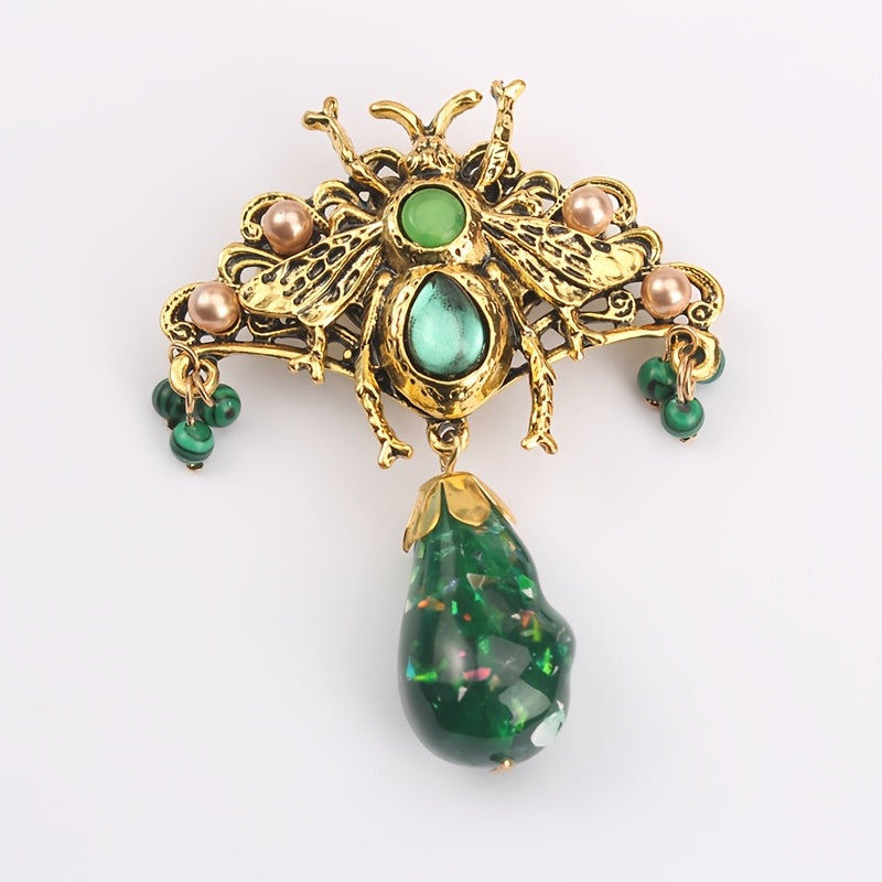 Bee brooch pin with vintage-inspired butterfly design, adorned with rhinestones and intricate green enamel accents, perfect for adding flair to coats and dresses.