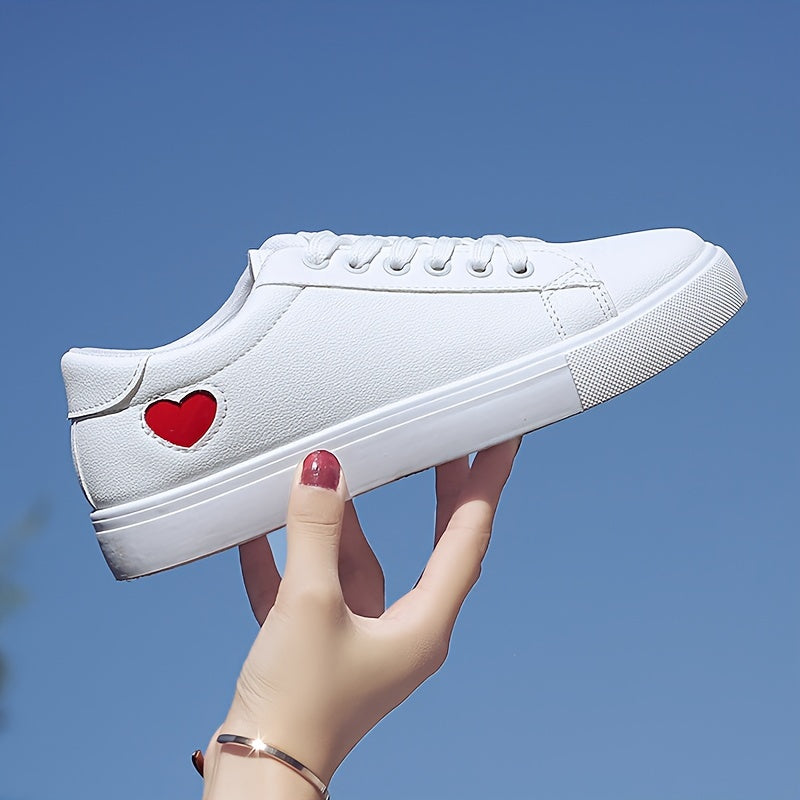 Stylish women's casual sneakers with heart-shaped design, lace-up style, and flat white soles - ideal for leisure wear.