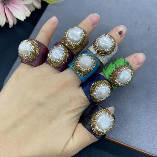 Casual yet sophisticated, this Boho-chic ring features genuine faux leather and snakeskin accents, along with a stunning baroque pearl and tourmaline. The adjustable open design adds versatility to your everyday attire.